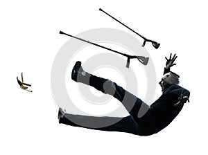 Injured man with crutches slipping silhouette