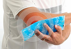 Injured Man using reusable ice gel packs his elbow, medical first aid after accident.