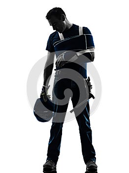 Injured manual worker man with injury brace despair silhouette