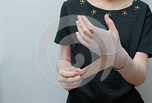 Injured painful hand with bandage on wrist