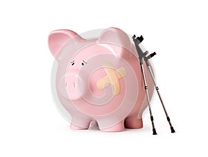 Injured piggy bank isolated on white