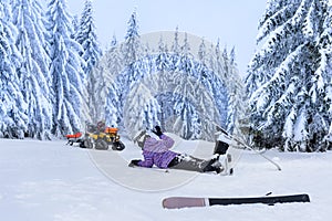 Injured skier after accident waiting for rescue