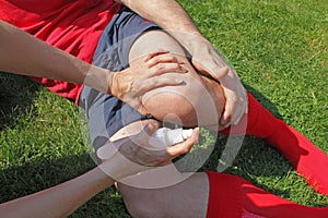 Injured Sportsman being helped by therapist