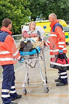 Injured woman talking with paramedics emergency photo