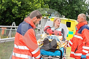 Injured woman talking with paramedics emergency photo