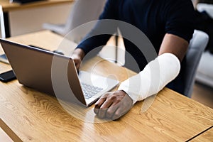 Injured Worker Compensation. Broken Arm African Man photo