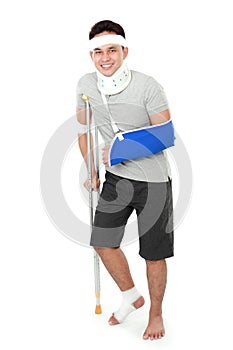 Injured young man wear arm sling and crutch