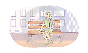 Injured young woman with broken arm sitting on bench outdoors