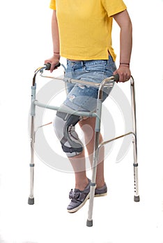 Injuried woman with walking frame and knee orthosis