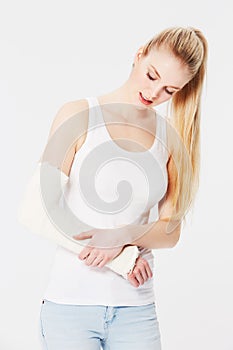 Injury, pain and woman with a broken arm after an accident isolated on a white background. Hurt, handicap and girl