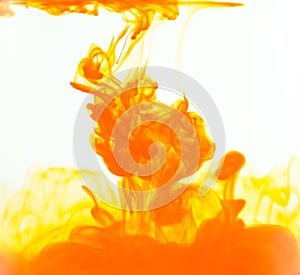 Ink drop, orange color drop in water. Cloud of ink in water on white background