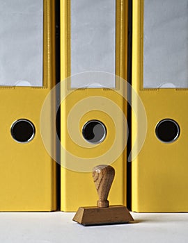 Ink stamp and yellow document folders.