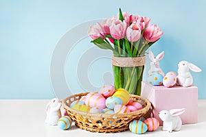 Ink tulips, easter bunnies with colorful eggs in basket and blue background