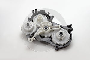 Inkjet printer paper feeder mechanical drive. four external spur gear wheels, with different gear ratios. reducer of plastic