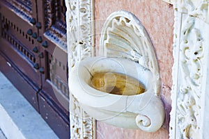 Inlaid marble holy water font in an Italian church