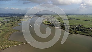 Inland container barge on River Lek aerial view near the village of Bergambacht, South Holland, Netherlands