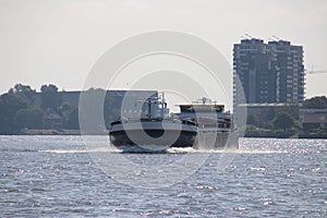 Inland freight ships on river Lek which transport seafreight to harbors in Germany and Switzerland