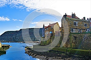 Inland view of Staithes harbour and Penny Nab, near Scarborough, in North Yorkshire.