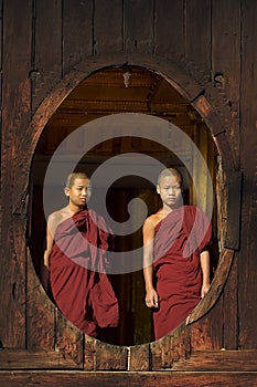 INLE LAKE, MYANMAR -November 18: Unidentified young monks look out of a monastery window from the Shwe Yaunghwe monastery in Nyaun