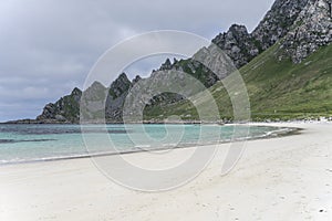 Inlet with clear water, white sand beach and steep rocks, Bleik , Norway