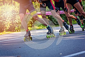 Inline roller skaters racing in the park o photo