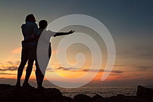 Inlove couple on the seacoast at sunset time