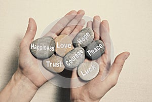 Inner balance concept: hands holding stones with the words happi