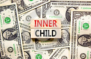 Inner child symbol. Concept words Inner child on beautiful wooden block. Beautiful background from dollar bills. Dollar bills.