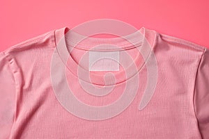 Inner collar of pink t-shirt with a blank label tag