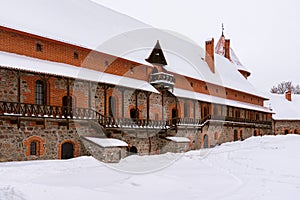 Inner courtyard of historical stone Trakai castle covered with snow, Lithuania. Winter landscape