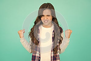 Inner energy. Little girl flex arms blue background. Small girl with long hair show strength. Fitness. Beauty and health