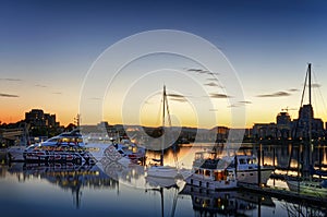 Inner Harbour of Victoria in sunset light. skyline with the bright evening lights of Victoria City, lights reflected on the water