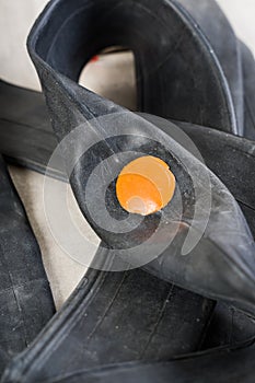 An inner tube with a patch on a punctured hole