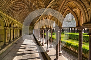 Inner yard garden surrounded by archade corridor of Saint-Michel abbey, France