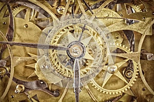 Innerworks of an antique clock with gear wheels