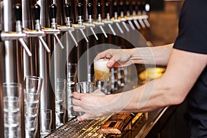 Innkeeper draws a beer at a beer pump