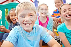 Innocence and positivity. A multi-ethnic group of happy children playing on a jungle gym in a play park.