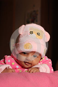 Innocent asian baby girl in pink winter cap