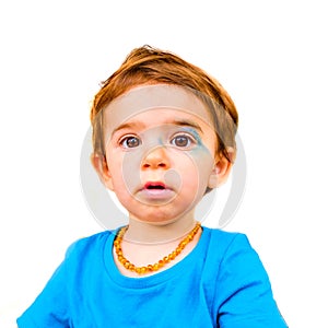 Innocent baby face isolated painted blue face expression newborn photo