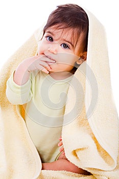 Innocent baby wrapped with a yellow towel