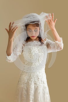 Innocent bride lifting her veil