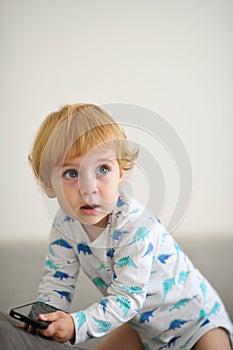 Innocent child playing music on a phone