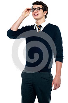 Innocent schoolboy adjusting his eyeglasses