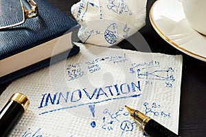 Innovation and business creative ideas written on a napkin.