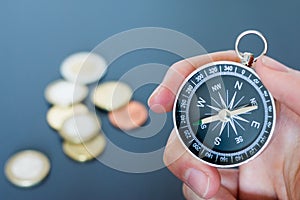 Innovation concept: Man is holding a compass in his hand, closeup cutout