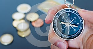 Innovation concept: Man is holding a compass in his hand, closeup cutout