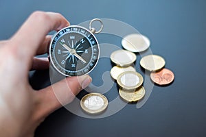 Innovation concept: Man is holding a compass in his hand, closeup cutout