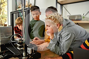 Innovation and Excellence. Caucasian girl is learning about working principle of 3d printer from her male teacher at