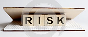 Innovation word RISK wood block on table for business concept