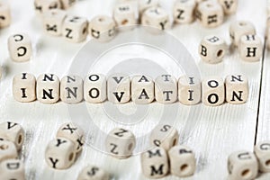 Innovation word written on wood block.